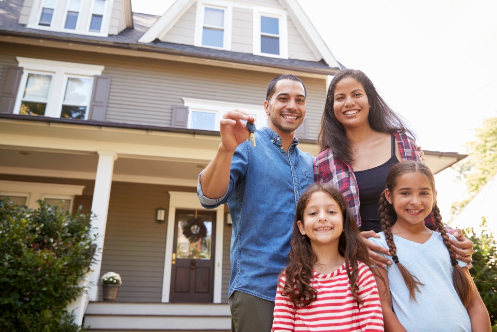 a family in front of a house