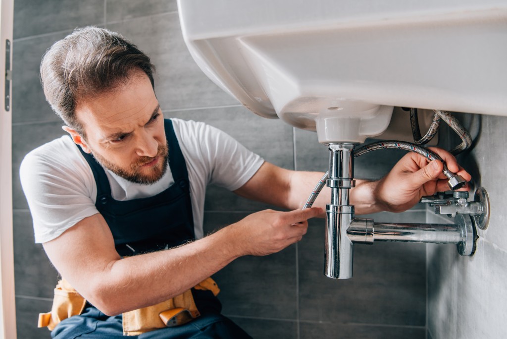 man installing bathroom sink