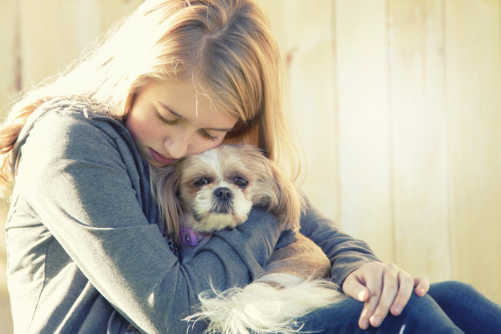 person hugging pet