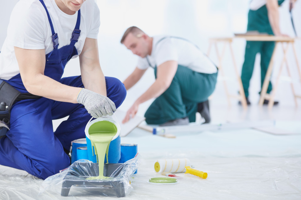 man pouring paint