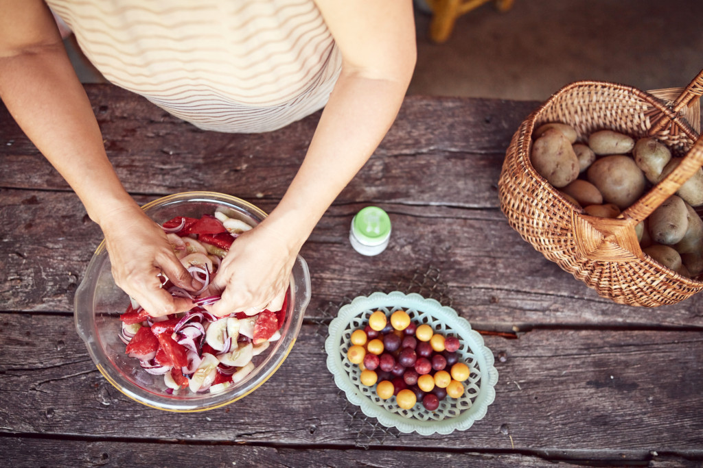 Woman preparing food in outdoor kitchen