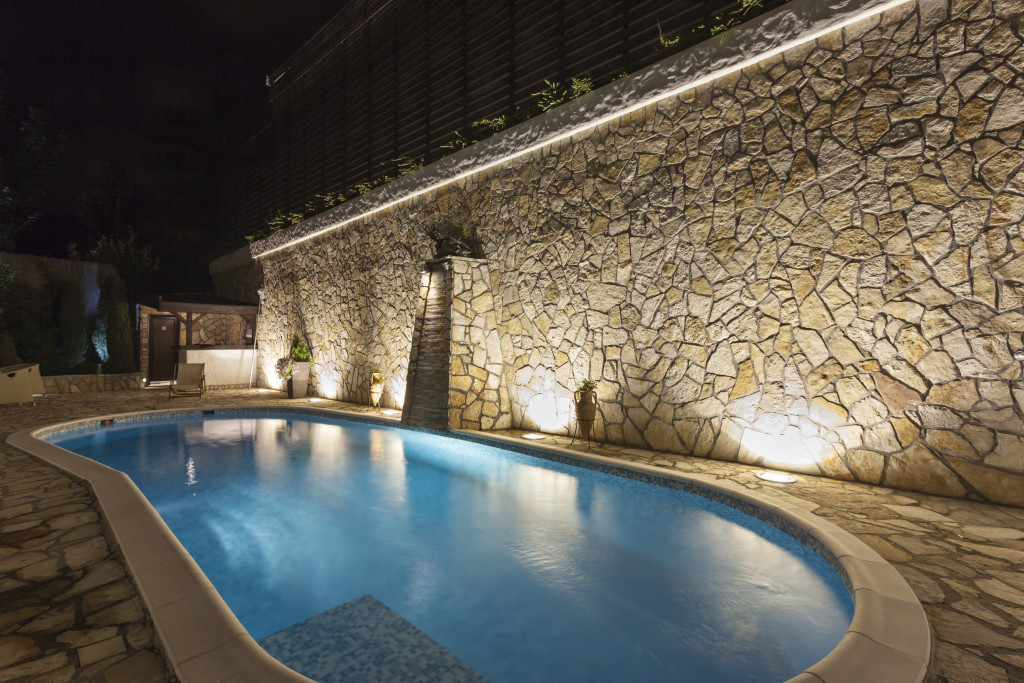 exterior lighting and a swimming pool